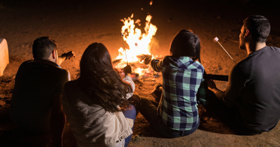A campfire roasting marshmallows as an nontraditional funeral idea.