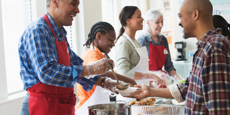 a group of people doing a community service project together