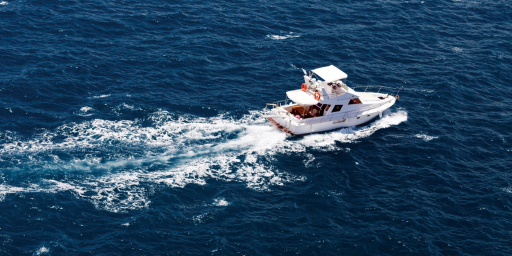 A yacht driving out in the water. 
