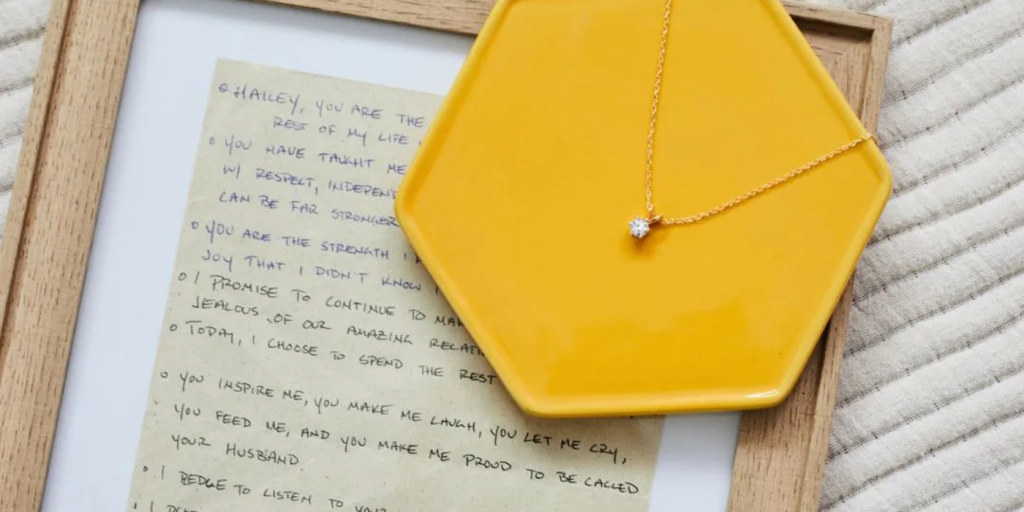 a necklace on top of a frame with cremations inside of the necklace